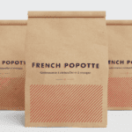 Three kraft paper bags with the "French Popotte" branding, featuring minimalist typography and red diagonal line patterns.